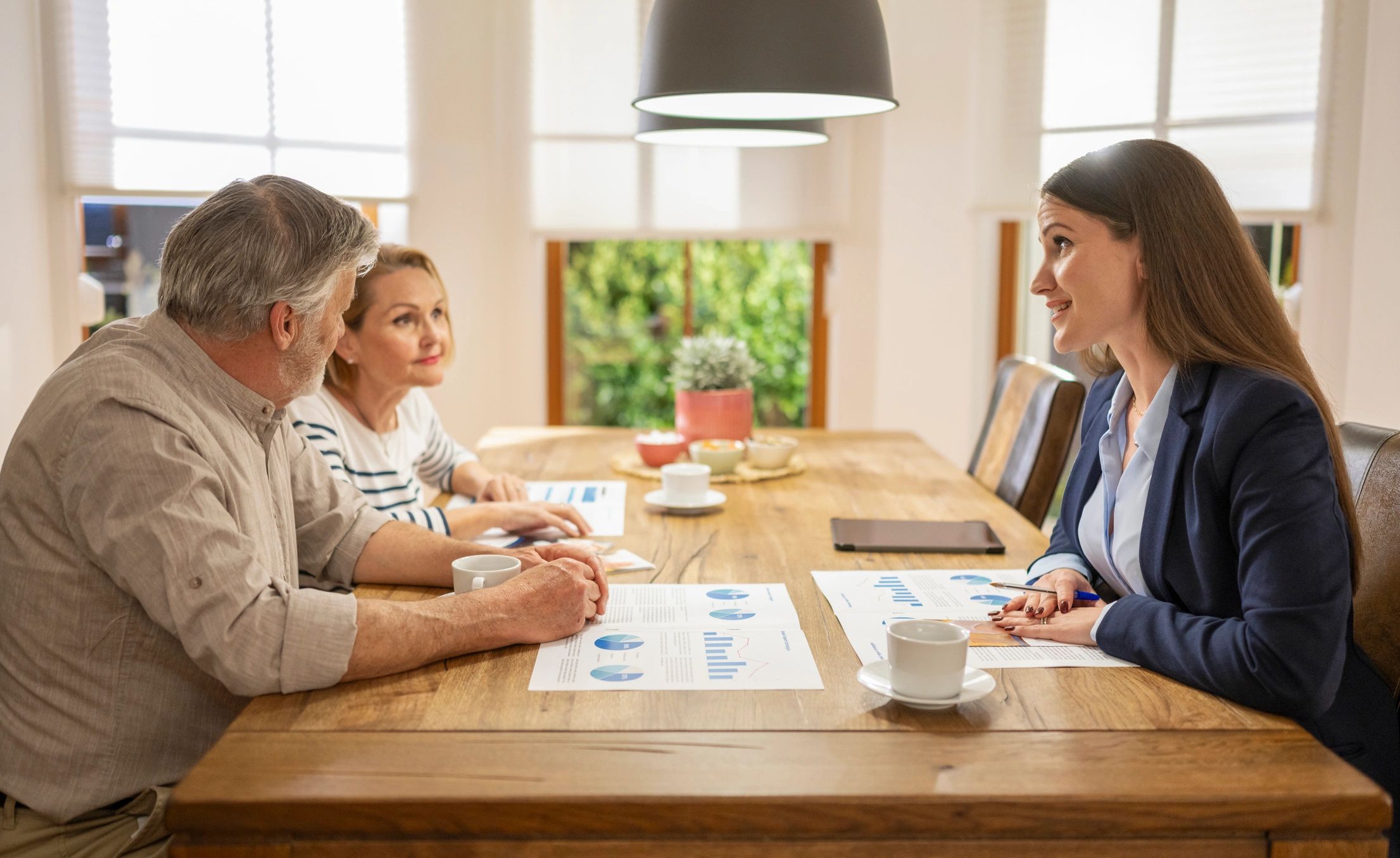 Real estate agent guiding an older couple through home decisions